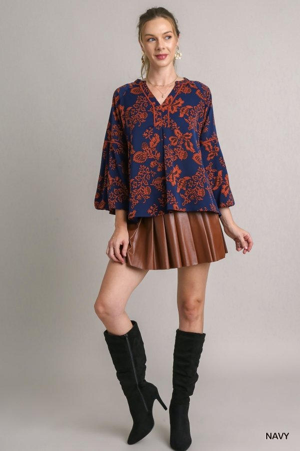 NAVY ORANGE PRINTED TOP from Raggdoll Boutique styled with pleated skirt and knee-high boots, perfect for summer outfits Texas.
