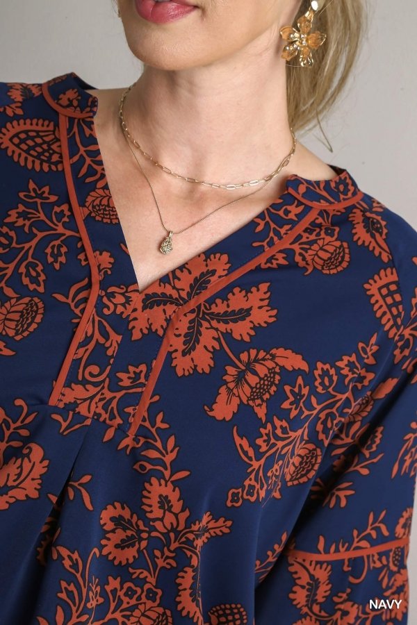 Navy orange printed top featuring floral design, perfect for coastal fashion at Raggdoll Boutique, summer outfits Texas.