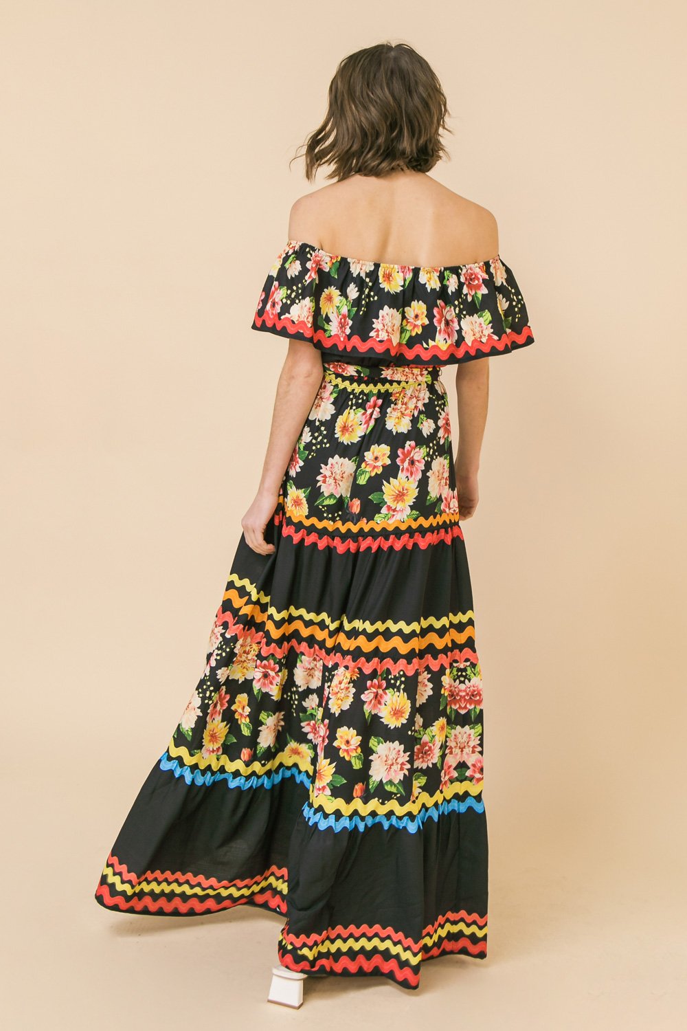 A model showcases the FLIRTY FIESTA DRESS from Raggdoll Boutique, perfect for trendy coastal style and summer outfits.