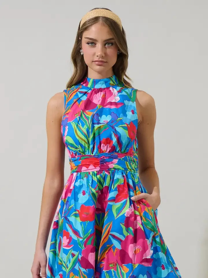 Model showcasing a vibrant floral mini dress, perfect for coastal boutique clothing and tropical vacation dresses.