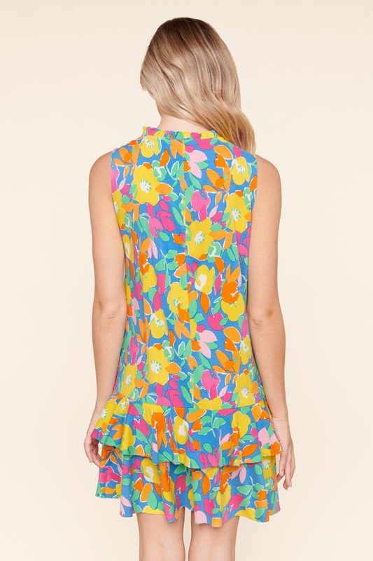 Back view of GRACELAND FLORAL DRESS showcasing bright colors and ruffled layers from Raggdoll Boutique.