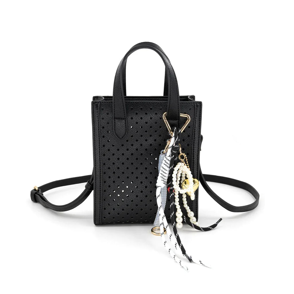 Ines Purse in perforated black with stylish accents, perfect for coastal boutiques and curated women's fashion.