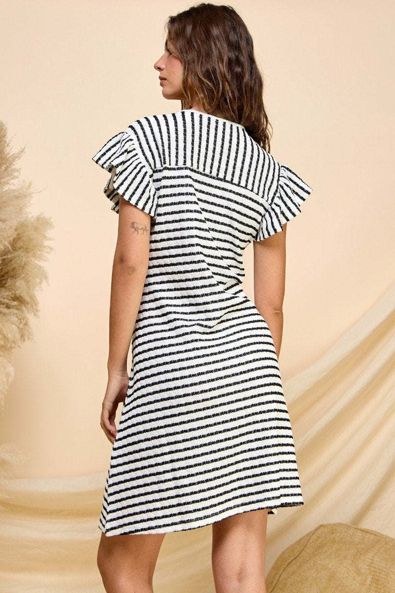 Back view of COASTAL CHARM STRIPE RUFFLE SLEEVE MINI DRESS from Raggdoll Boutique, showcasing trendy coastal style.