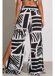 BARBADOS PRINT PANTS worn sideways, showcasing trendy coastal style perfect for summer outfits at Raggdoll Boutique.