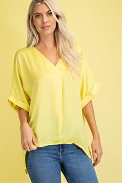 YELLOW SATIN HI-LO TOP modeled by woman, perfect for summer outfits Texas from Raggdoll Boutique, Port Aransas.