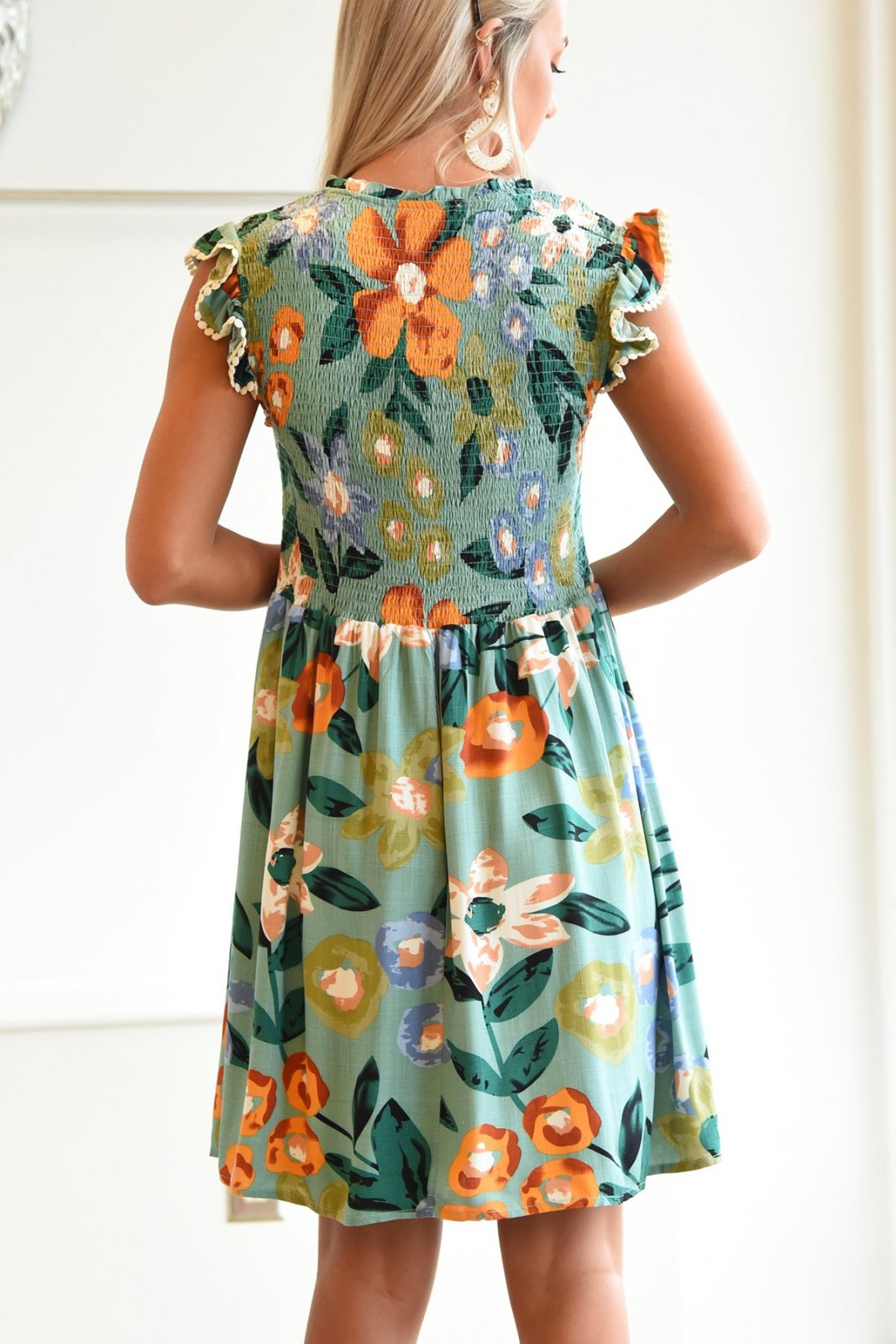 Back view of the Sweet As Can Be dress, featuring floral patterns, perfect for coastal boutique clothing and beach dresses.