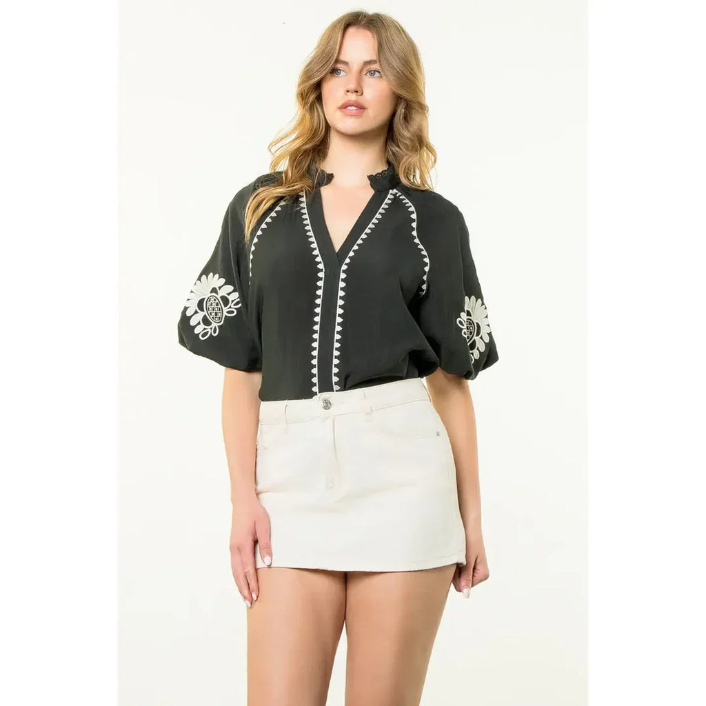 Stylish black and ecru embroidered top, perfect for coastal boutique clothing and tropical vacation dresses.