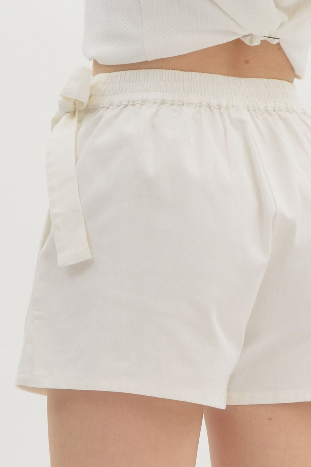 Stylish white skort with braided waist detail, perfect for summer at a coastal boutique, women's bottoms, Port Aransas fashion.