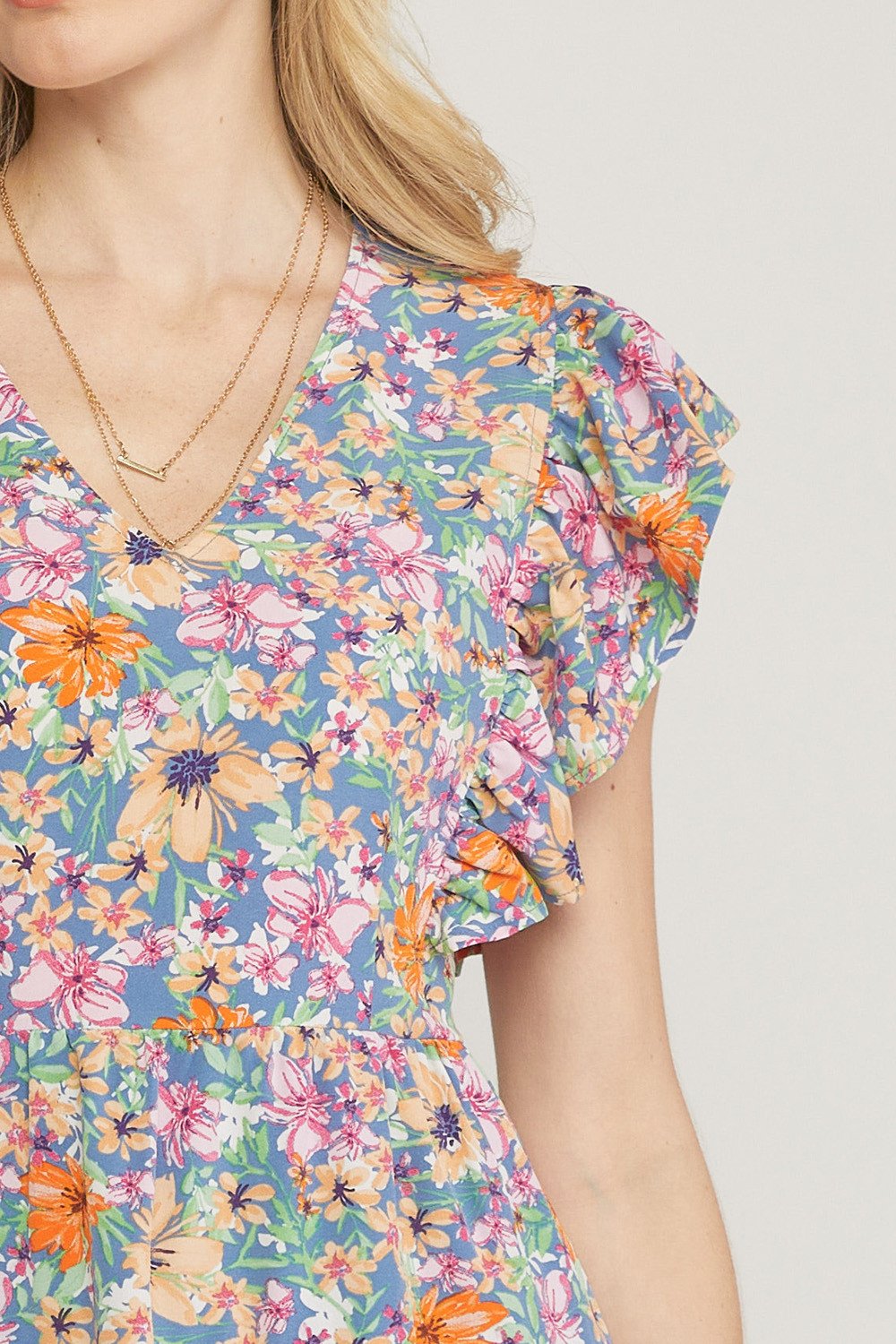 Close-up of the FIELD OF FLOWERS DRESS featuring vibrant floral patterns from Raggdoll Boutique.