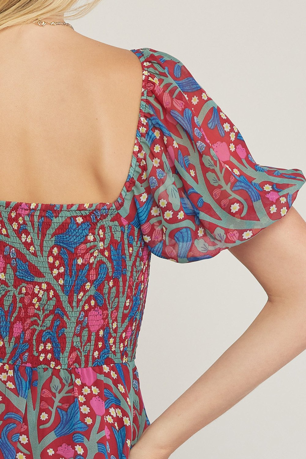 TIME TO CELEBRATE DRESS back detail featuring colorful floral print and puff sleeves from Raggdoll Boutique.