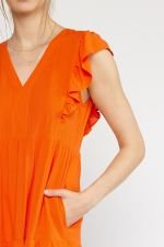 COAST TO COAST DRESS in vibrant orange with frill sleeves, perfect for summer outfits Texas and trendy coastal style.
