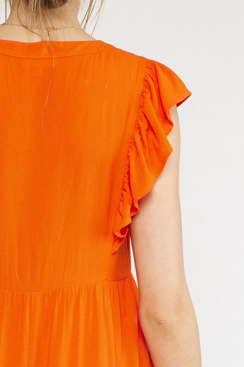 Back view of COAST TO COAST DRESS showcasing ruffle details in vibrant orange at Raggdoll Boutique, Port Aransas boutique.