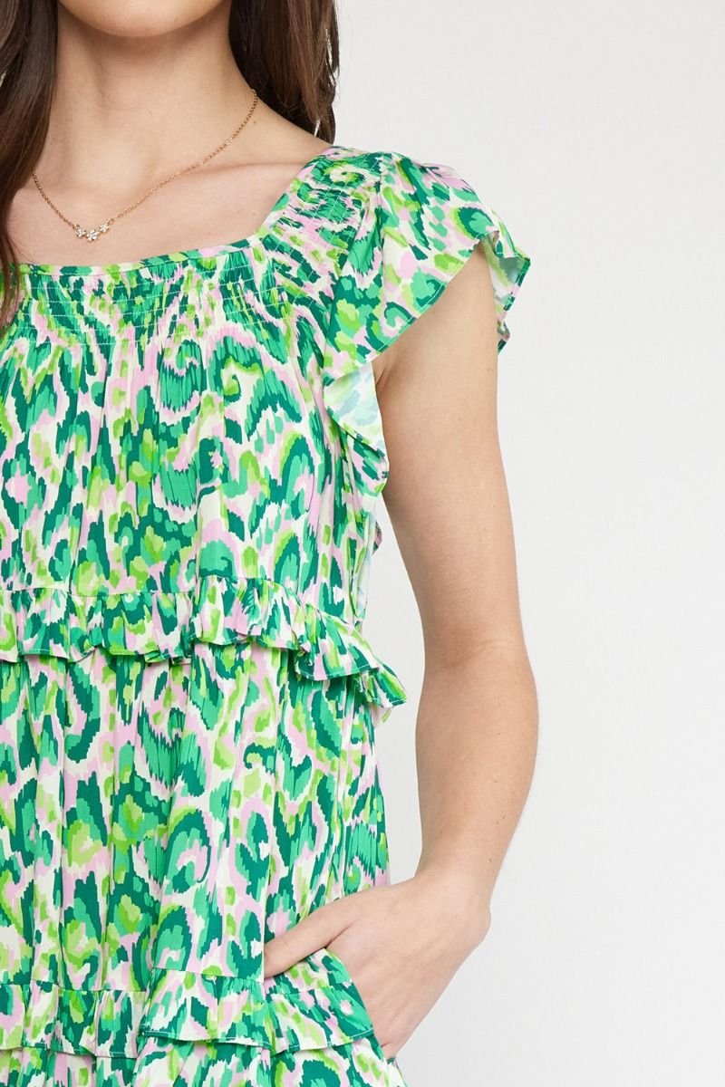 Girls Love Swirls dress in vibrant green, perfect for coastal boutique clothing and stylish summer beach outings.