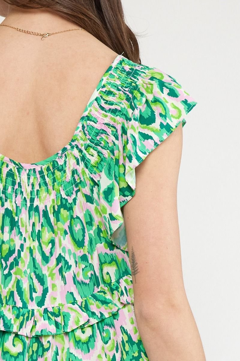 Close-up of the back of a colorful girl's dress featuring frill sleeves, perfect for coastal boutique clothing.