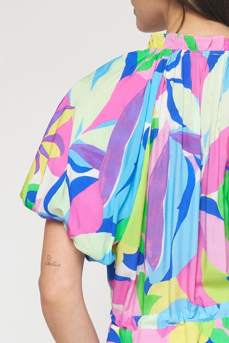 Color Crush Dress in vibrant tropical print, perfect for coastal boutique clothing. Ideal for beach days and stylish vacations.