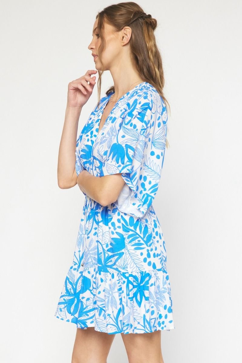 Side view of LOOKING LOVELY DRESS in blue floral print, perfect for coastal boutique clothing and tropical vacations.