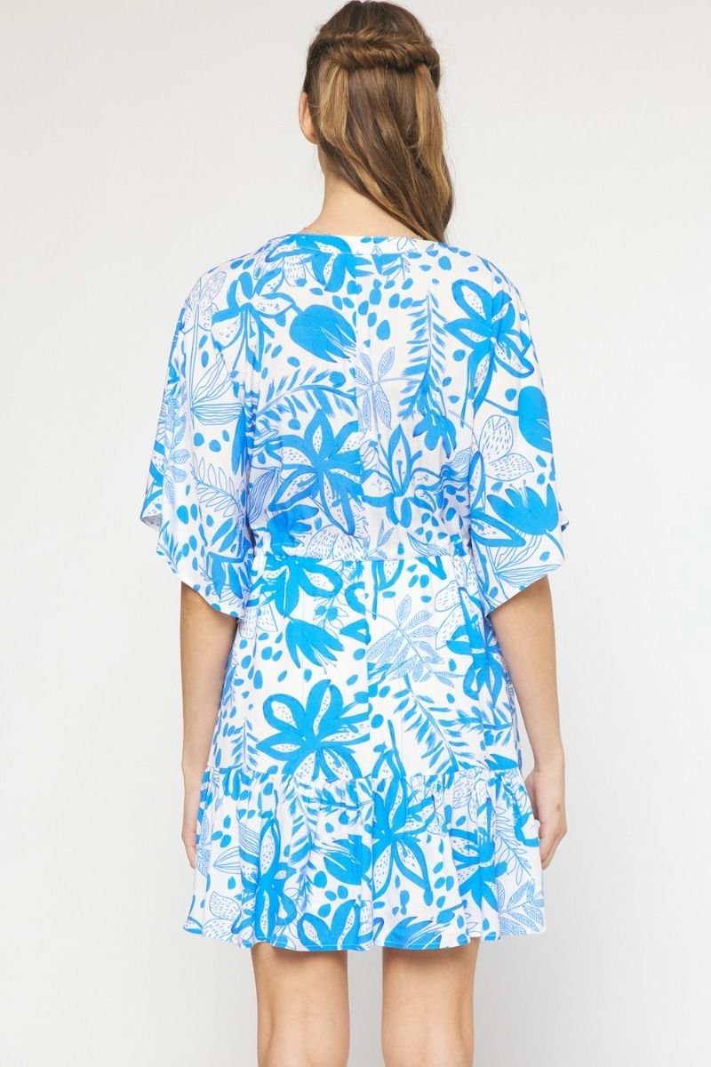 Back view of the OCEAN VIEWS DRESS in blue floral print from Raggdoll Boutique, ideal for coastal fashion.