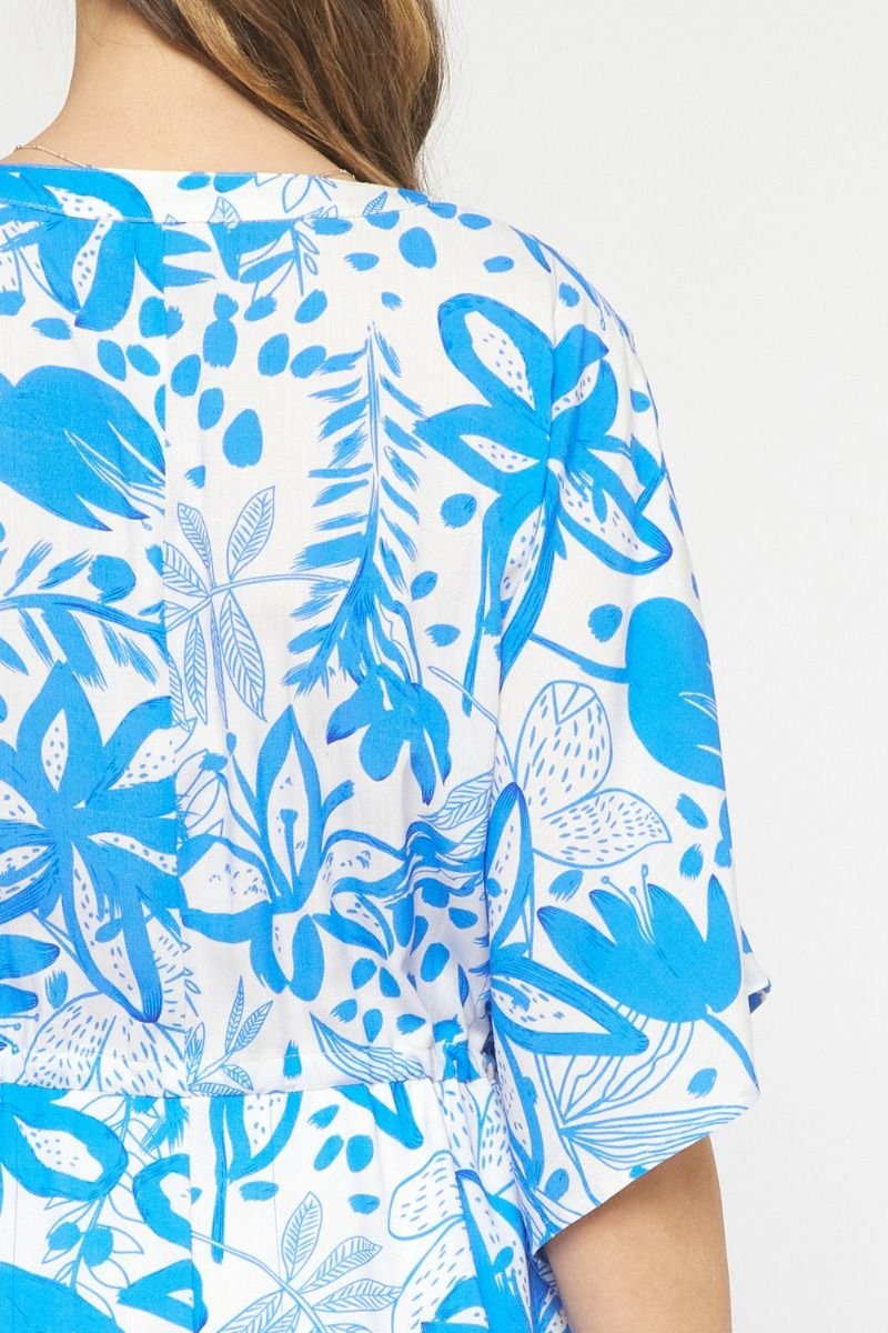 Back view of a floral beach dress featuring blue tropical prints, perfect for curvy fashion lovers and coastal boutiques.