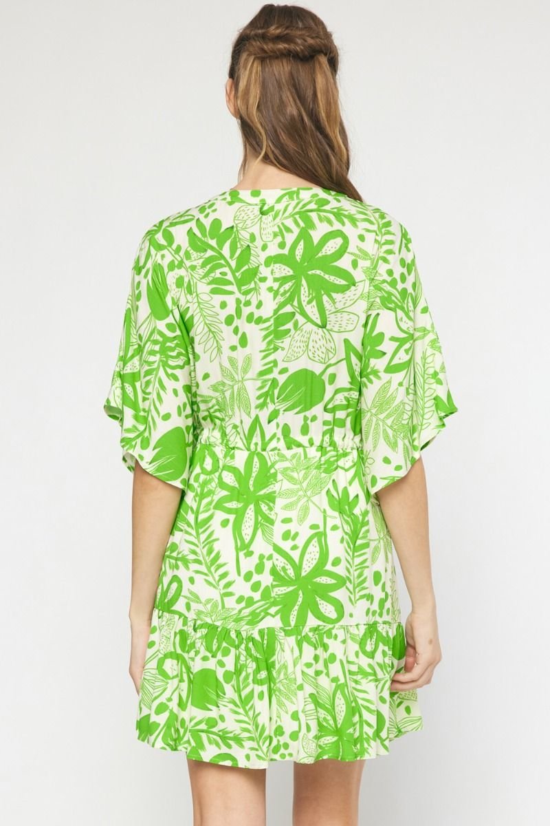 Back view of SWEET GREEN DRESS with a floral print, perfect for summer outfits at Raggdoll Boutique in Port Aransas.