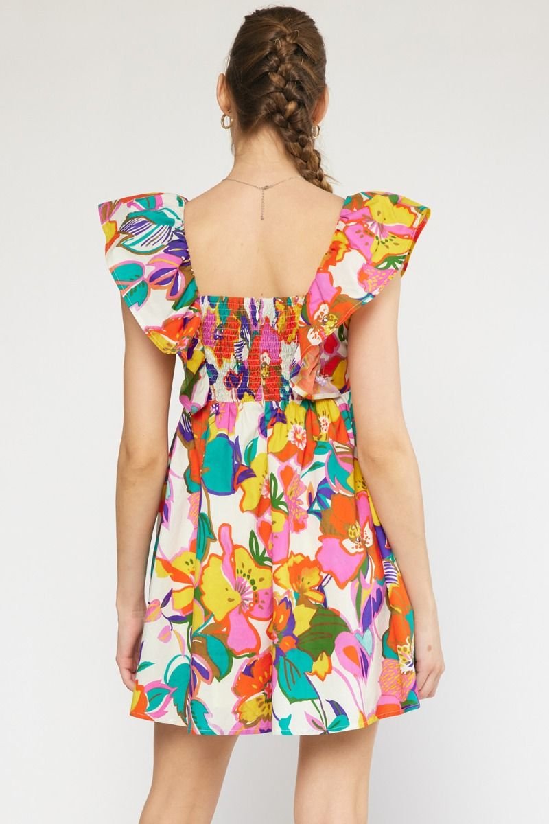 Flirty in Floral Dress showcased at Raggdoll Boutique in vibrant summer colors, perfect for vacation wardrobe.