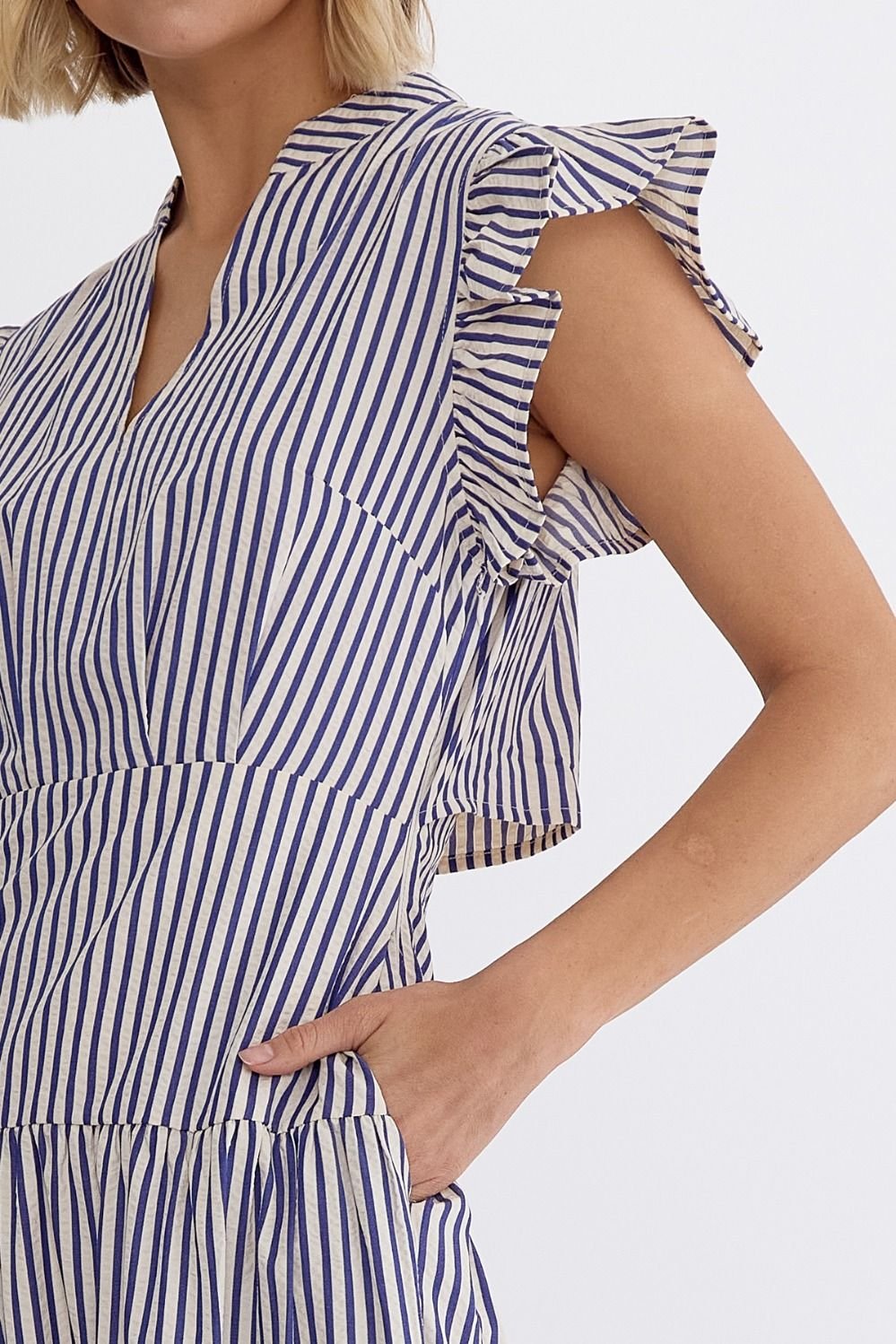 Close-up of a woman wearing the BLUE SKY STRIPED MIDI dress from Raggdoll Boutique, showcasing its trendy coastal style.