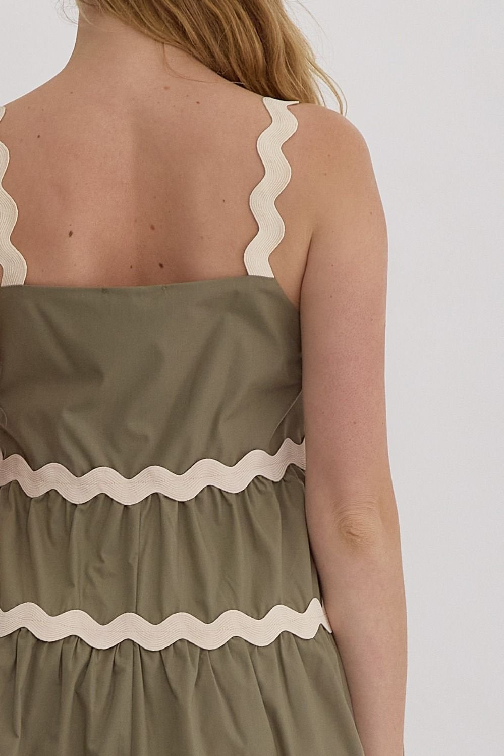 Back view of the Olive Dress featuring ruffled layers, perfect for trendy coastal style at Raggdoll Boutique.