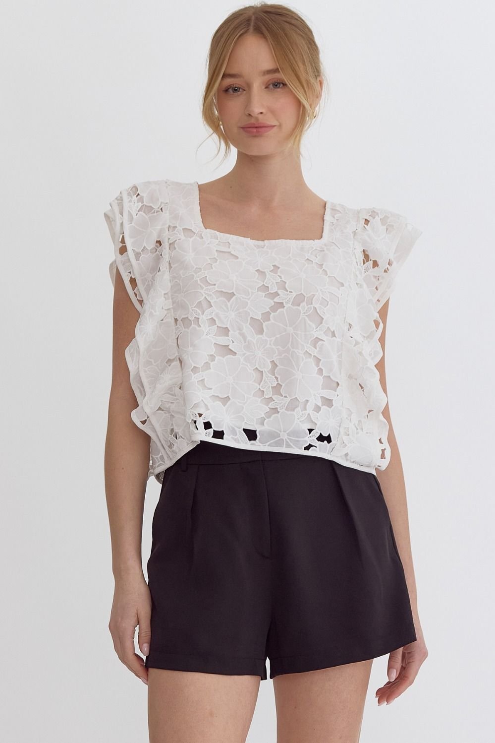 Model wearing a White Lace Cut-Out Top paired with shorts from Raggdoll Boutique, perfect for summer outfits Texas.