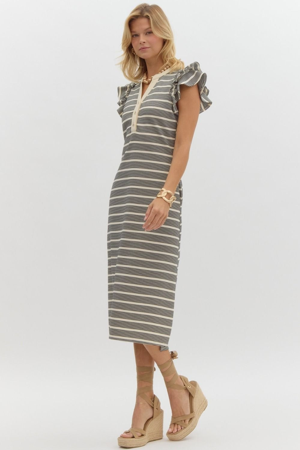 Stylish Tori Dress from a coastal boutique, perfect for beach outings and tropical vacations, featuring trendy stripes and ruffles.