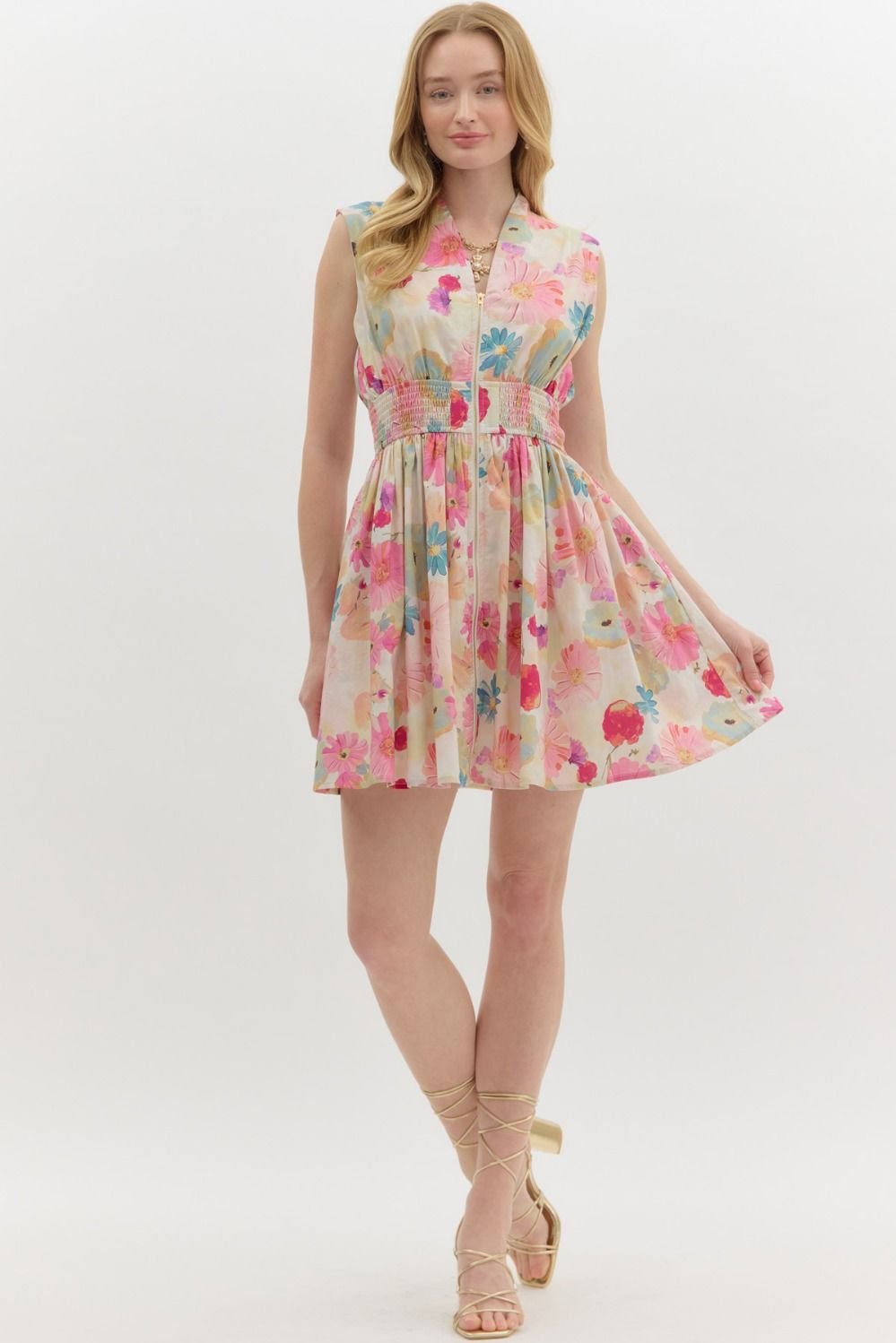 Floral summer mini dress in vibrant hues from a coastal boutique, ideal for tropical vacations and beach outings.