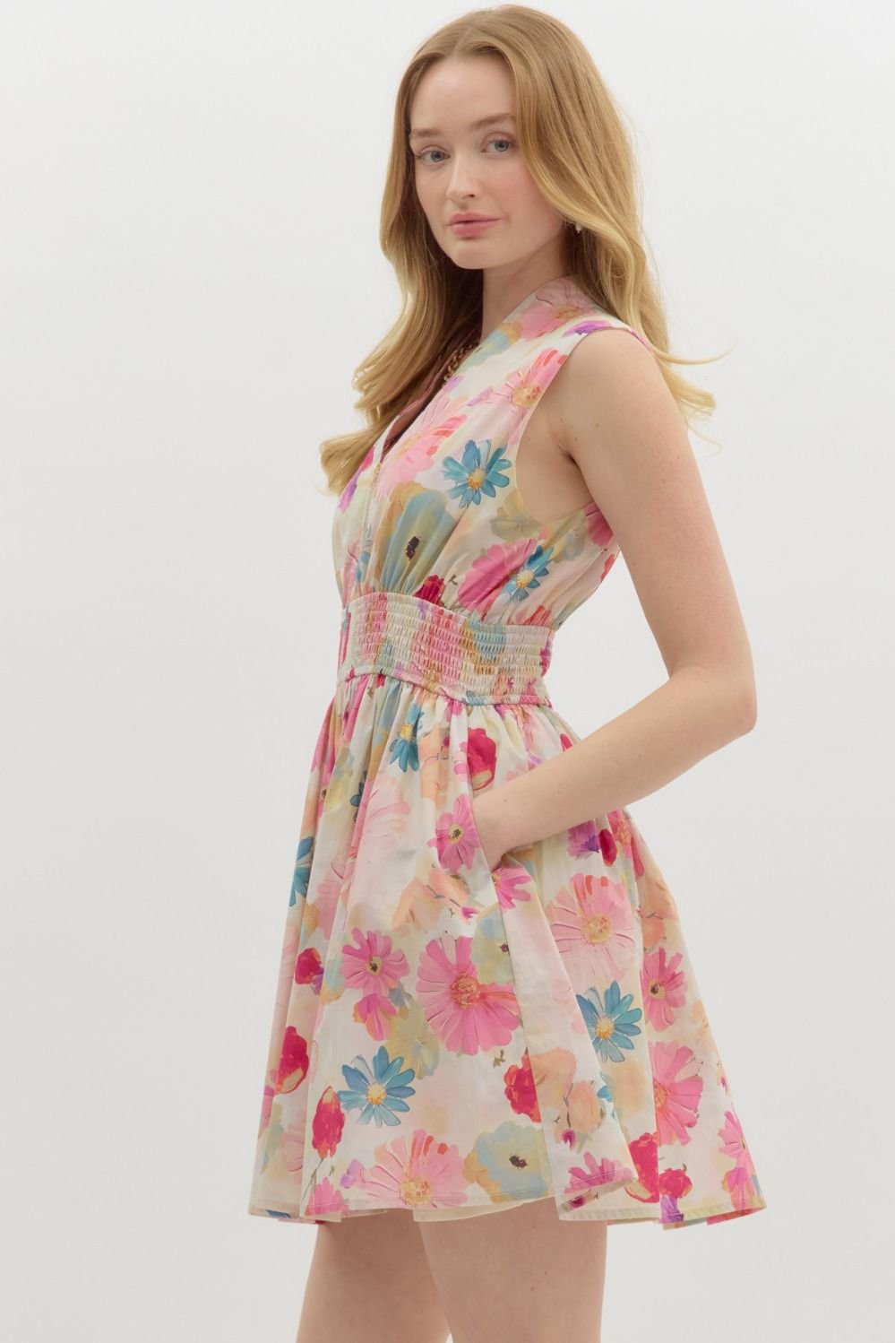 Floral summer mini dress with V-neckline and pockets, ideal for tropical vacations. From a Port Aransas boutique.