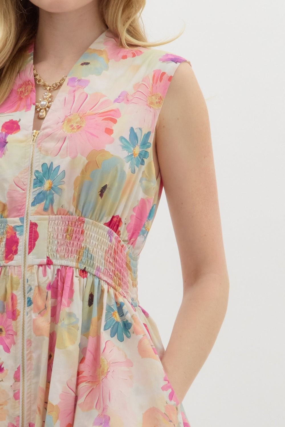 Floral summer mini dress from Port Aransas boutique, featuring a V-neckline, smocked waistband, and side pockets.