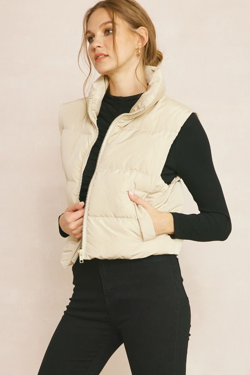 PUFFER VEST SANDSTONE displayed in a trendy outfit at Raggdoll Boutique, perfect for summer outfits in Texas.