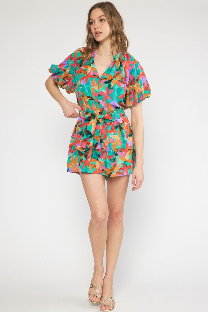 Model wearing GREEN MULTI FLORAL ROMPER from Raggdoll Boutique, showcasing trendy coastal style.