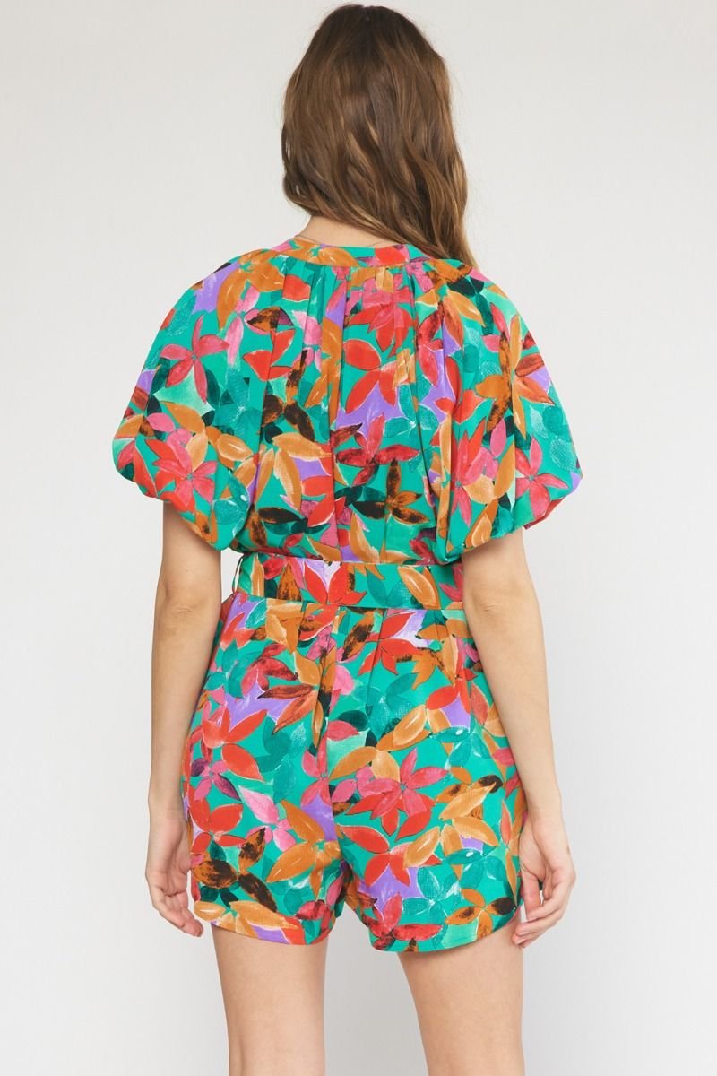 Back view of GREEN MULTI FLORAL ROMPER from Raggdoll Boutique, perfect for trendy coastal style and summer outfits Texas.