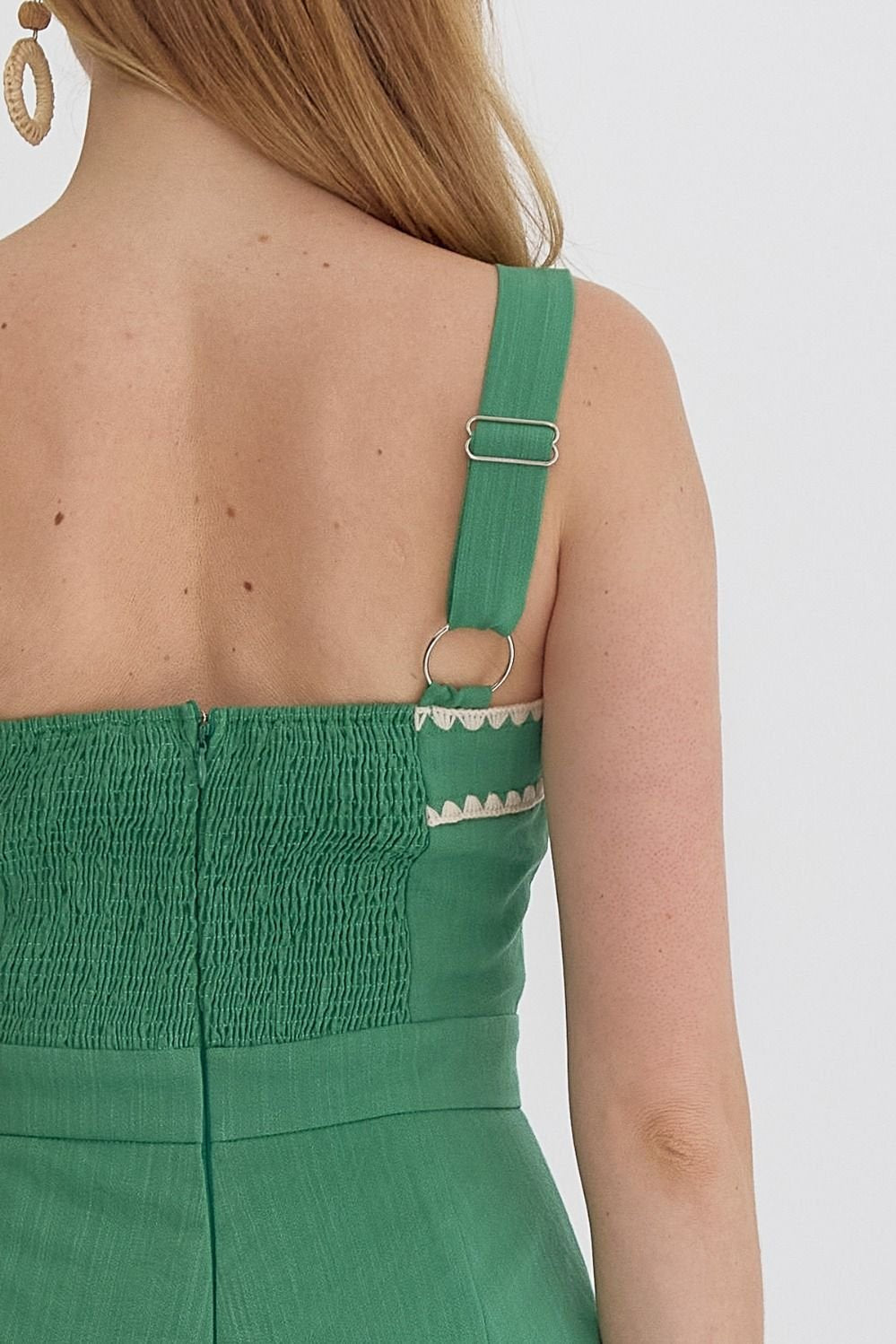 Back view of Piper Romper showcasing its green fabric and stylish strap details from Raggdoll Boutique.
