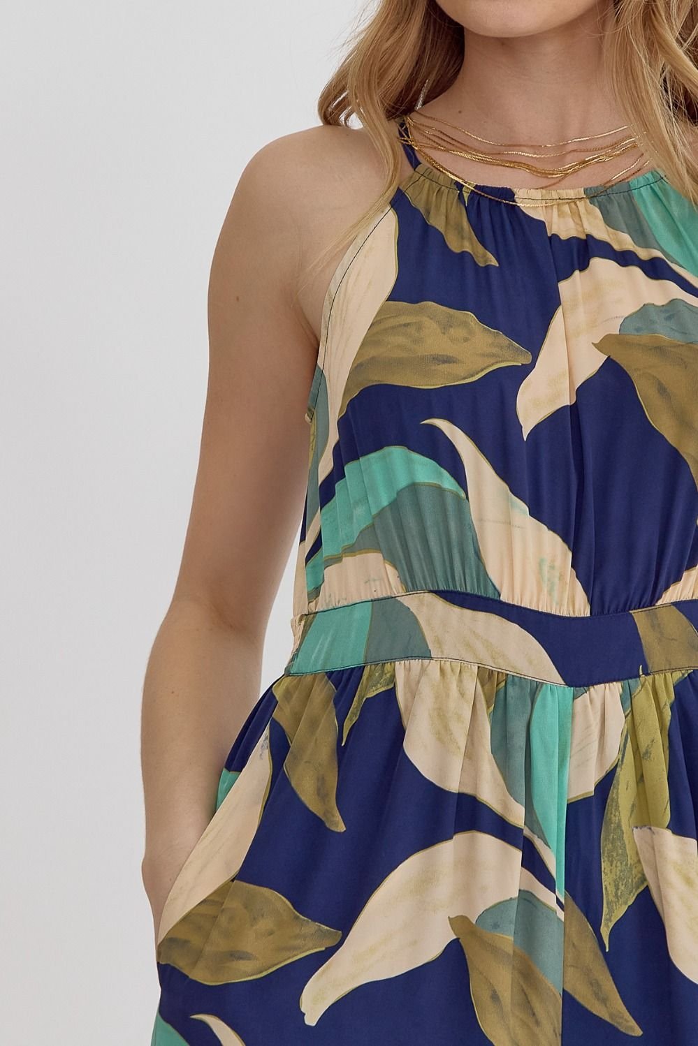 Stylish navy and greens jumpsuit for women, perfect for tropical vacations and coastal boutique clothing. 100% polyester.