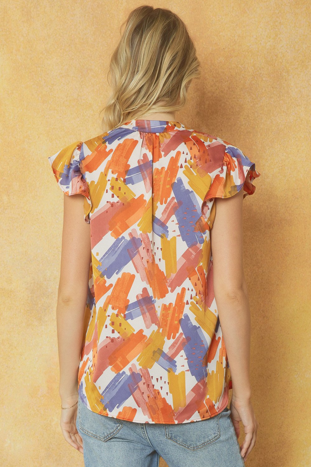 Back view of SLATE BLUE AND RUST GRAPHIC TOP, trendy coastal style from Raggdoll Boutique in Port Aransas.