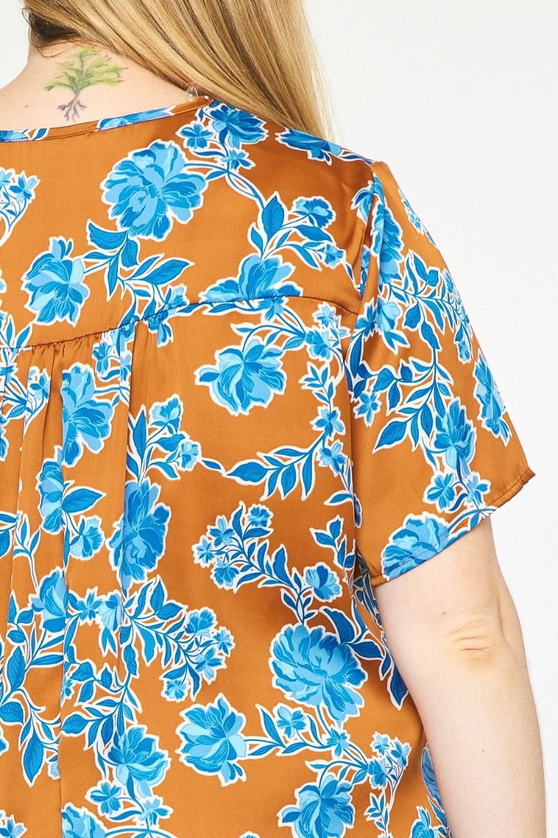 COPPER PLUS FLORAL TOP featuring bright blue floral patterns on a warm copper background, ideal for coastal fashion.
