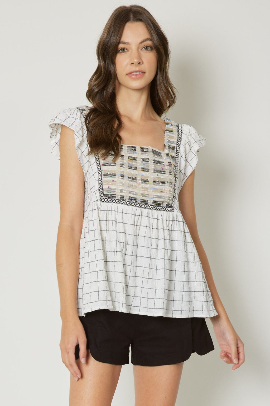 Cream babydoll top with detail, perfect for coastal boutique clothing and beach dresses for stylish summer looks.