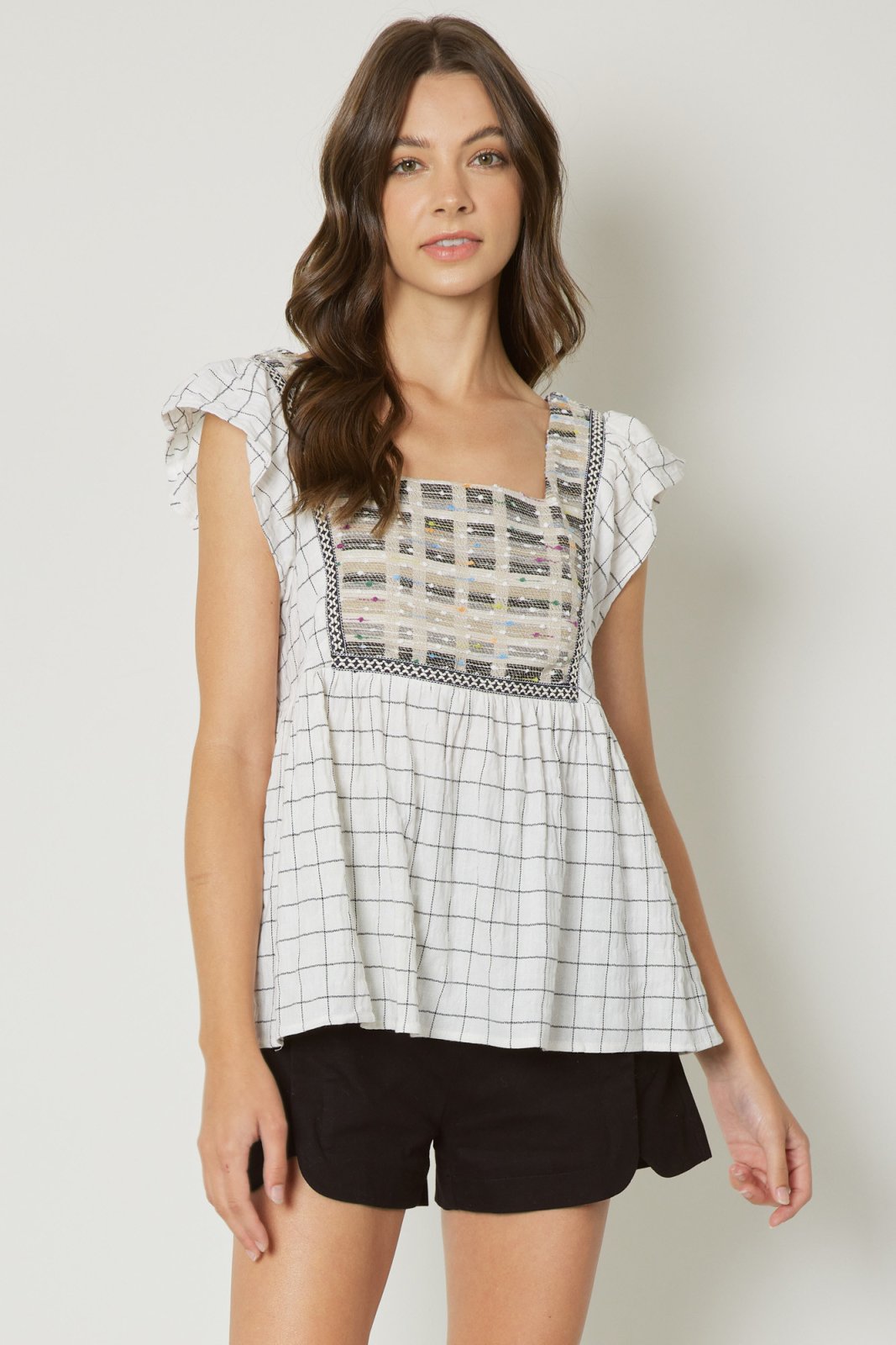Cream babydoll top with detail, perfect for coastal boutique clothing and beach dresses for stylish summer looks.