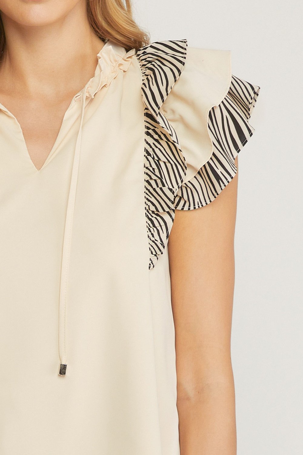 CREAM AND BLACK WITH SLEEVE DETAIL from Raggdoll Boutique, a trendy coastal fashion boutique in Port Aransas.