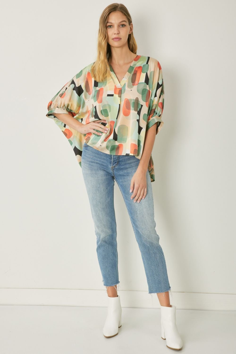 Stylish Mint Multi Graphic Top paired with jeans, perfect for coastal boutique clothing and tropical vacation dresses.
