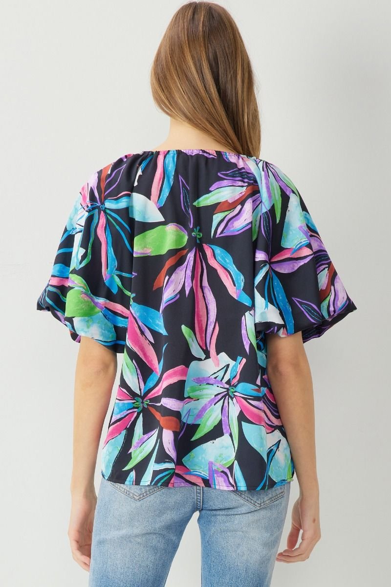 Back view of the MULTI BLACK BUBBLE SLEEVE TOP featuring vibrant floral design, perfect for summer outfits Texas.