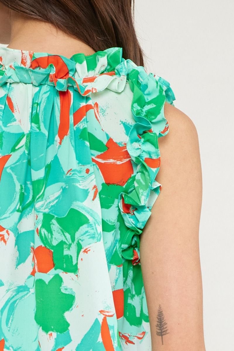 Close-up of the back of a woman wearing a GREEN, RED, WHITE TOP with ruffle details from Raggdoll Boutique.
