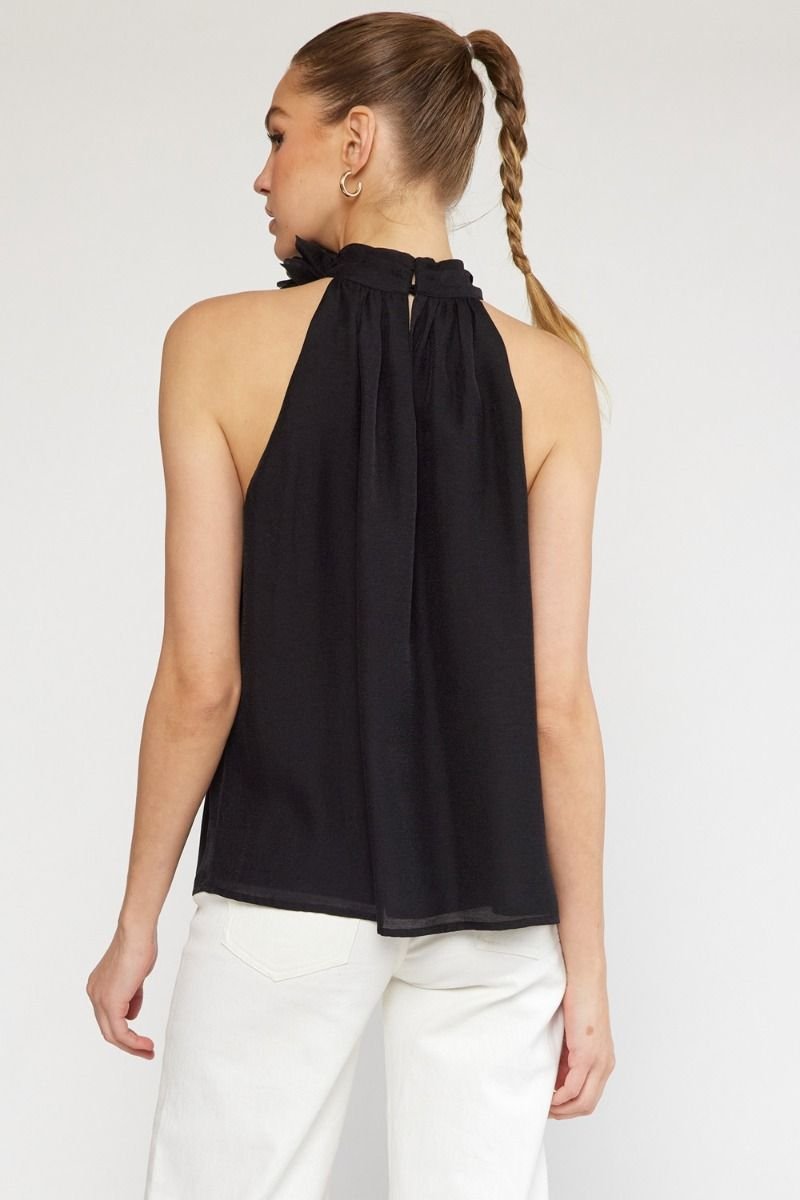 BLACK HALTER TOP WITH FLOWER DETAIL showcasing the back design, perfect for coastal fashion from Raggdoll Boutique.