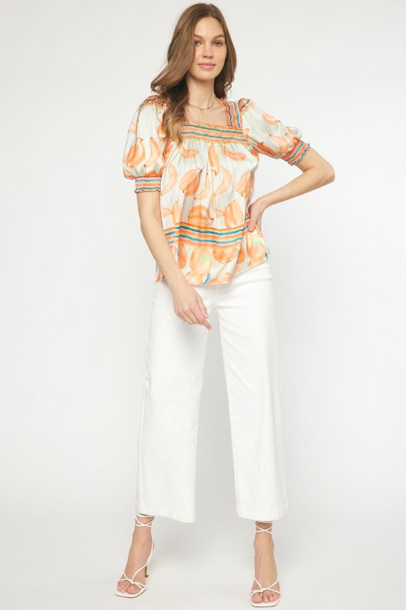 Model wearing ORANGE MULTI TOP from Raggdoll Boutique, perfect for trendy coastal style and summer outfits Texas.