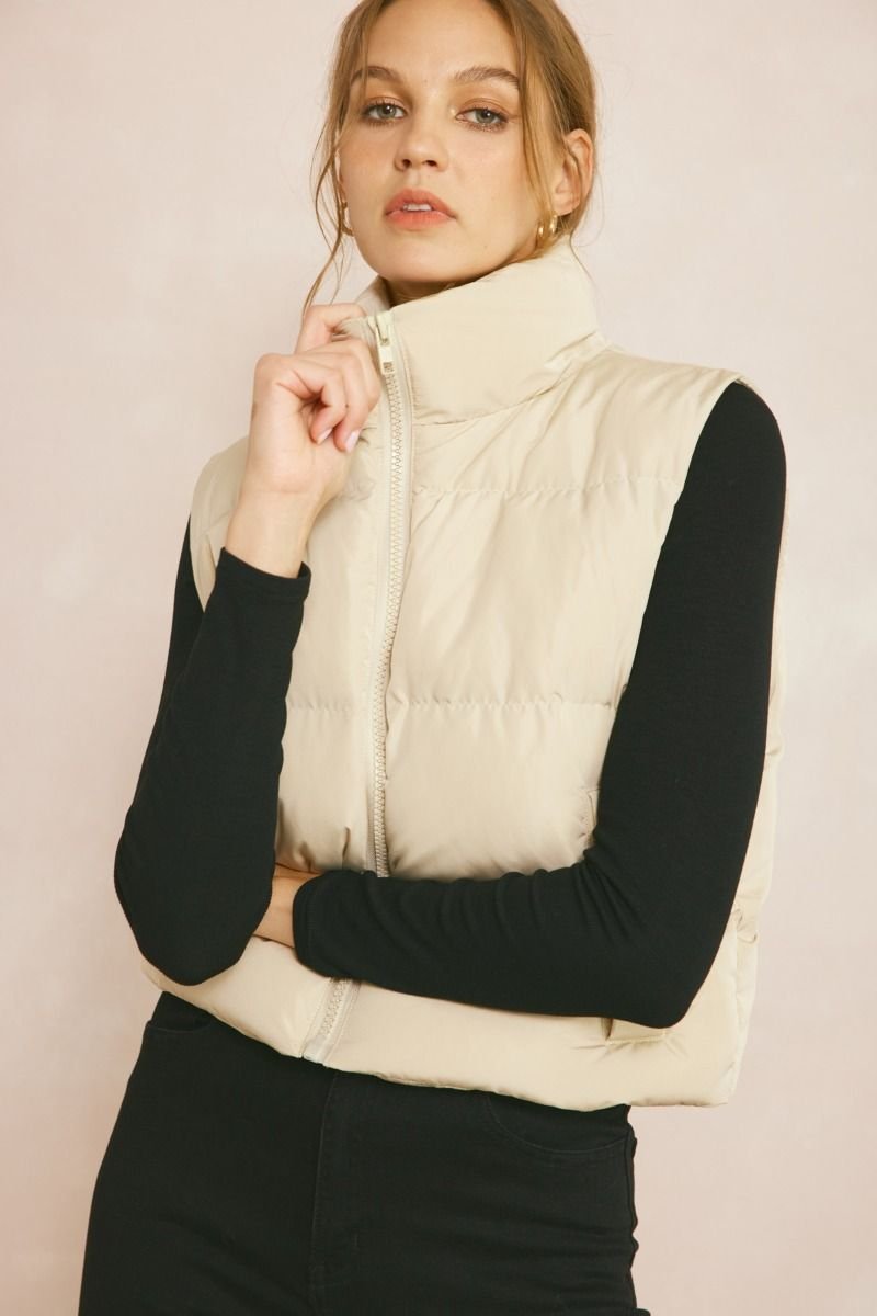 PUFFER VEST SANDSTONE featured at Raggdoll Boutique, a coastal fashion boutique in Port Aransas for trendy summer outfits.