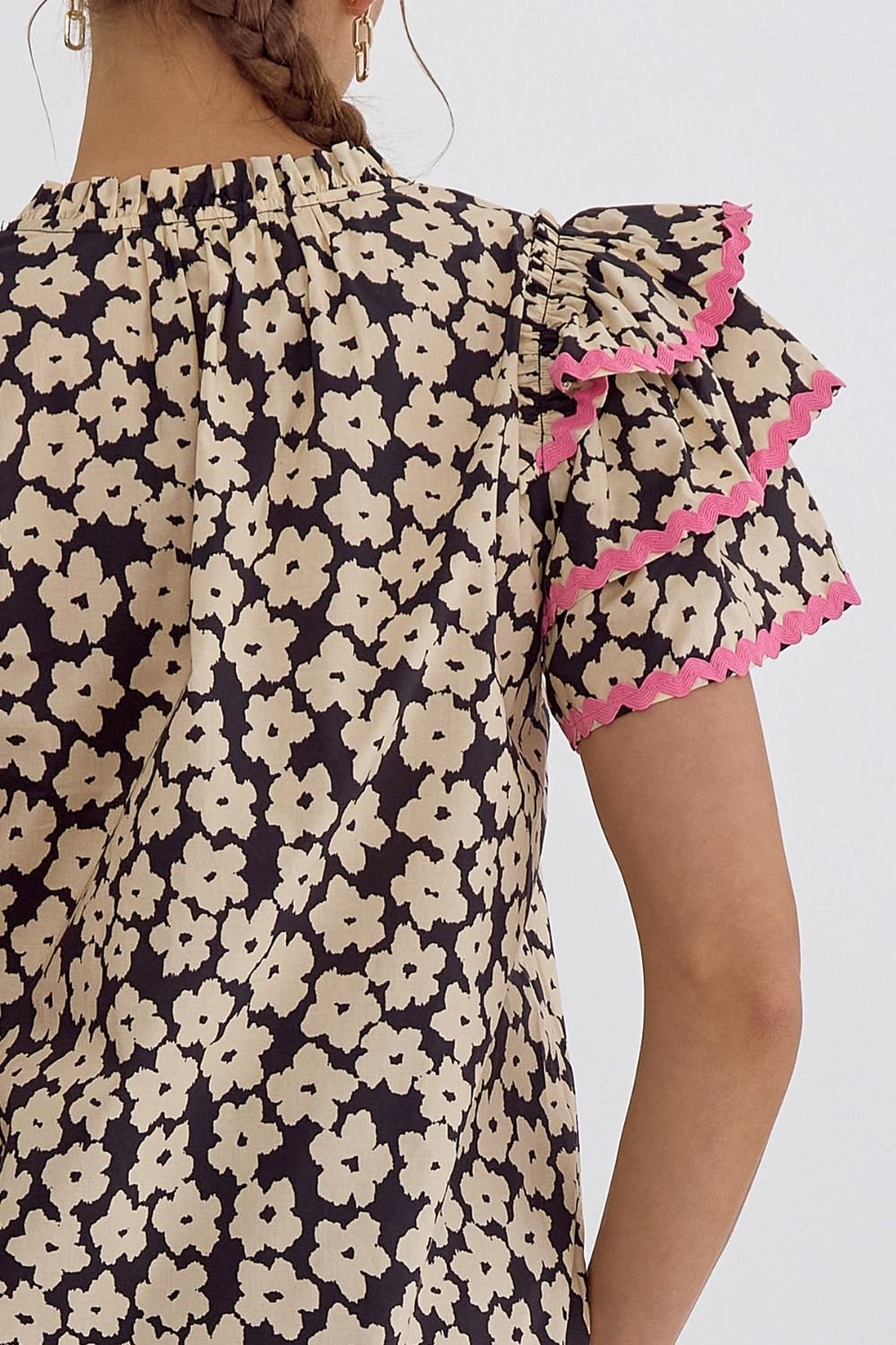 Stylish floral top with ruffled sleeves, perfect for coastal boutique clothing and beach dresses from Port Aransas.