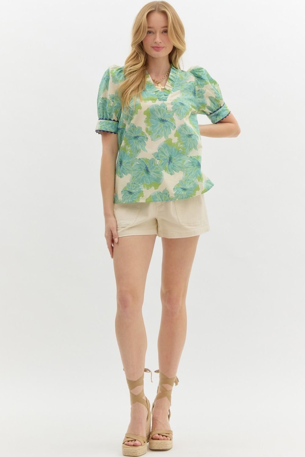Green floral top with neck detail, perfect for coastal boutique clothing or tropical vacation dresses in Port Aransas.