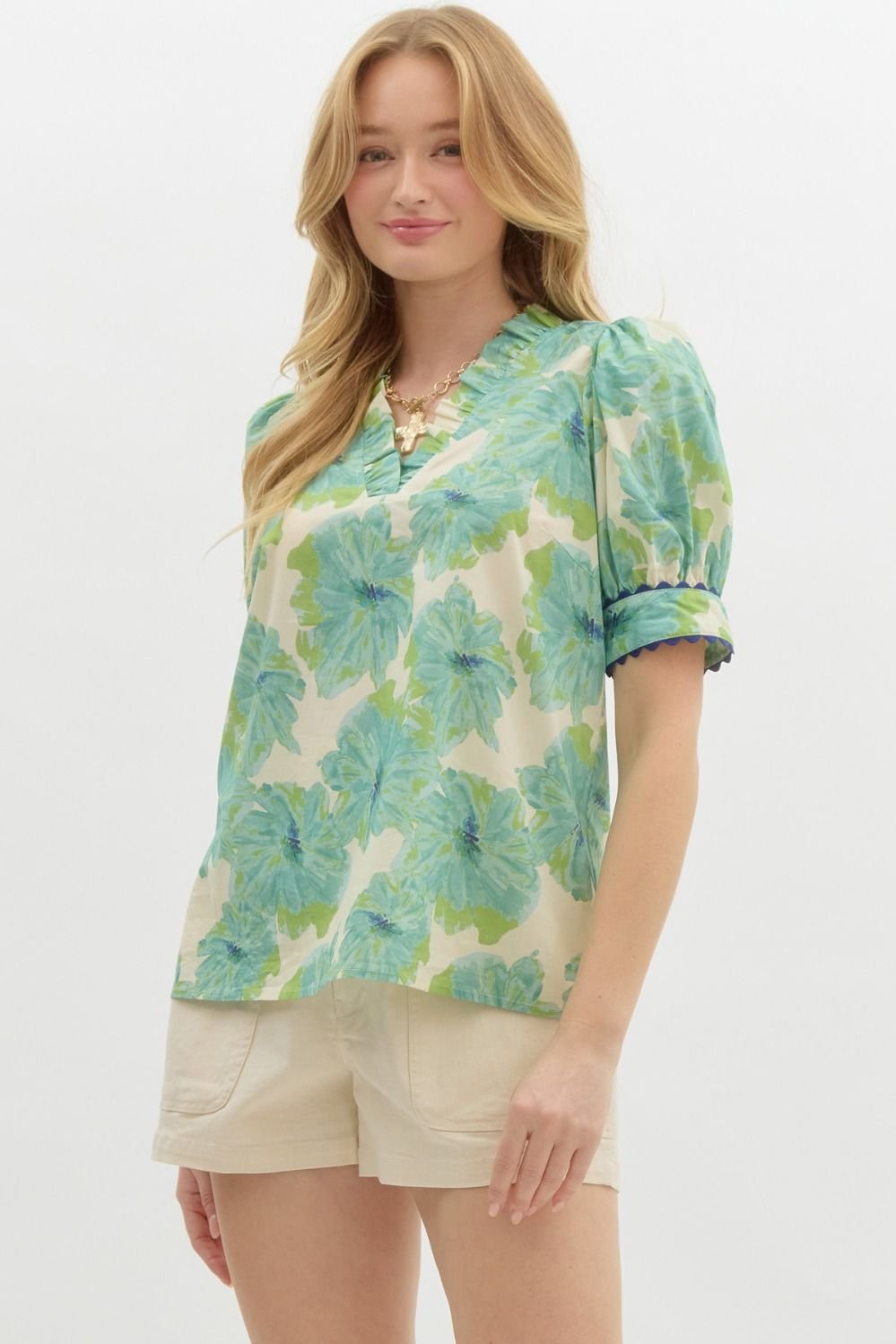 Stylish green floral top with neck and sleeve detail, perfect for coastal boutique clothing and tropical vacation dresses.